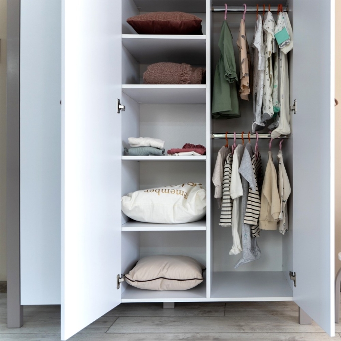 a closet with clothes and pillows